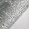 Modern non-woven wallpaper with linen texture and tropical leaf pattern in square blocks in beige/green tones