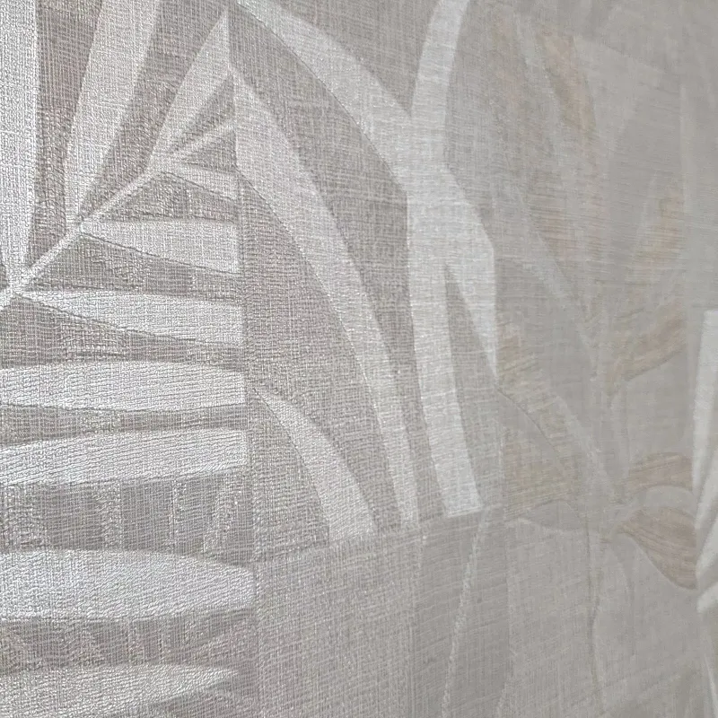Modern non-woven wallpaper with linen texture and tropical leaf pattern in square blocks in light beige/cream tones